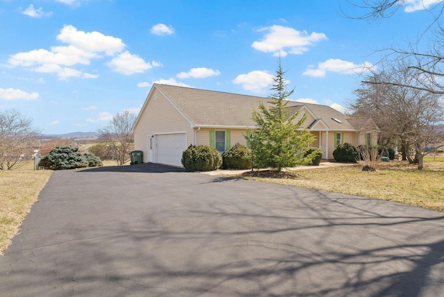 view of front of home featuring aphalt driveway and an attached garage