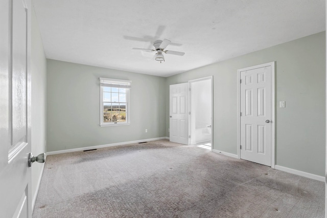 unfurnished bedroom featuring visible vents, a ceiling fan, baseboards, and carpet floors