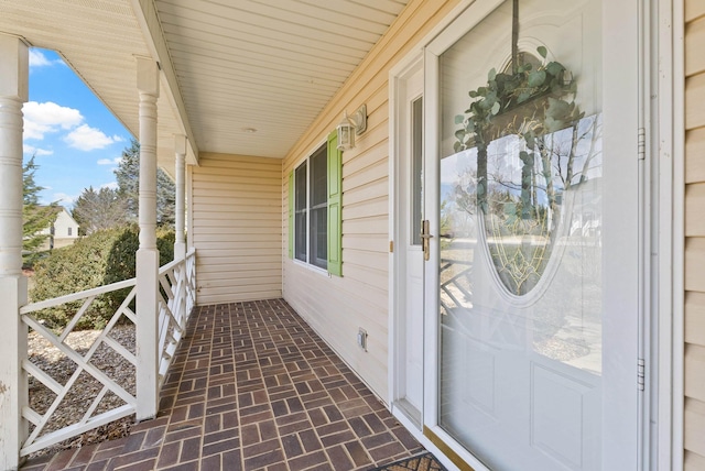 view of exterior entry with a porch