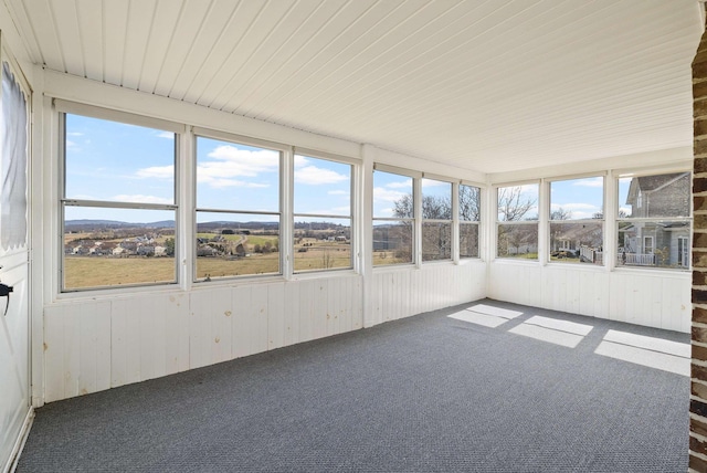 unfurnished sunroom featuring wooden ceiling