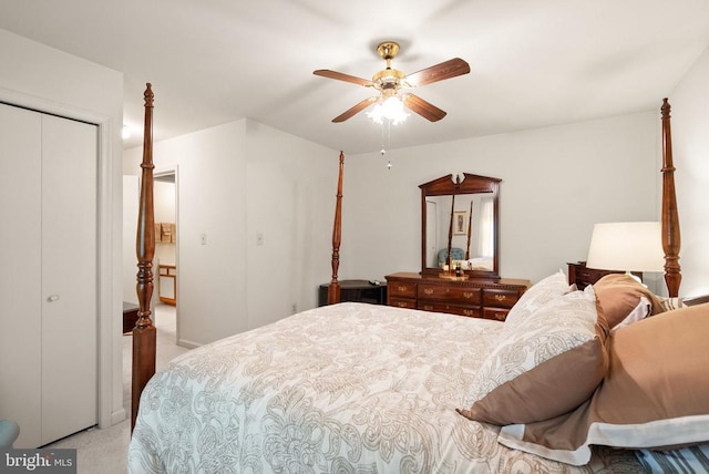 bedroom with light colored carpet, a ceiling fan, and a closet