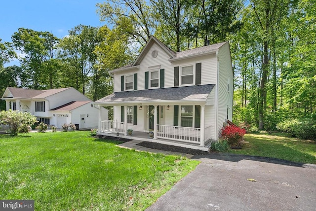 view of front facade featuring covered porch and a front lawn
