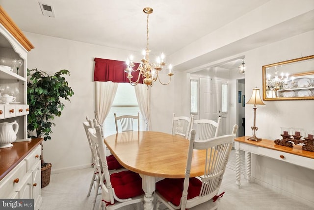dining space with light colored carpet, a chandelier, plenty of natural light, and visible vents