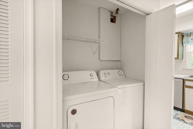 washroom with separate washer and dryer and laundry area
