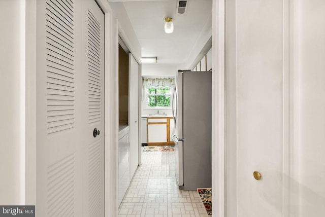hall with a sink and visible vents