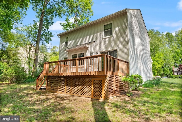 rear view of house featuring stairs, a yard, and a deck