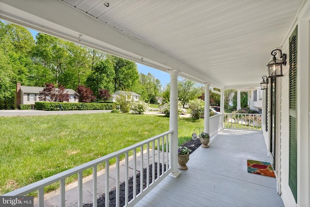 deck featuring a yard and a porch