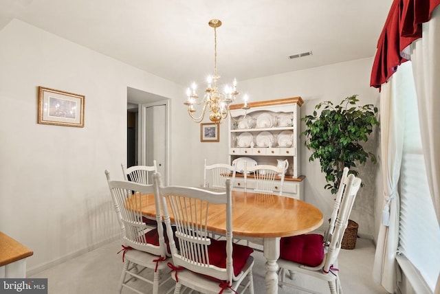 dining space with baseboards, a notable chandelier, and visible vents