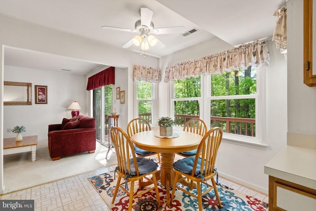 dining room featuring ceiling fan, visible vents, and baseboards