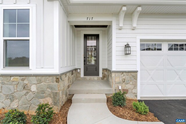 doorway to property with a garage