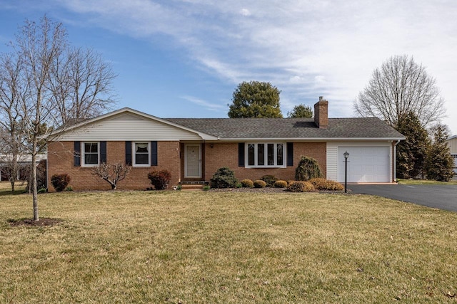 single story home featuring a front yard, an attached garage, driveway, and a chimney