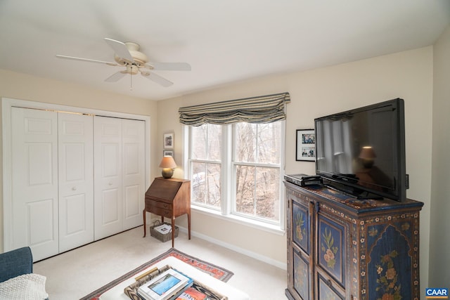 sitting room featuring light carpet and ceiling fan