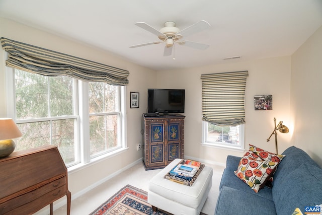 carpeted living room featuring ceiling fan