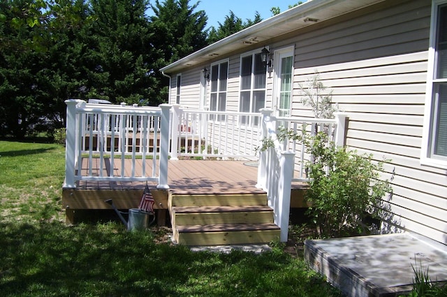 wooden deck featuring a lawn