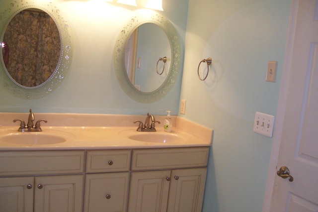 full bath with double vanity and a sink