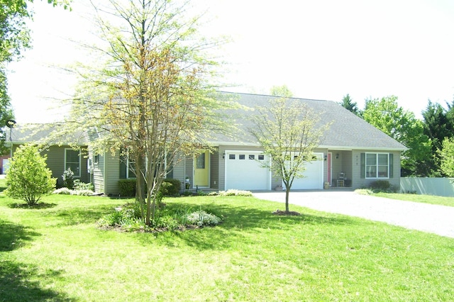 view of front of home with a front yard, driveway, and an attached garage