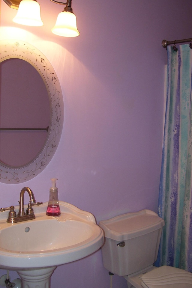 full bathroom featuring toilet and a sink