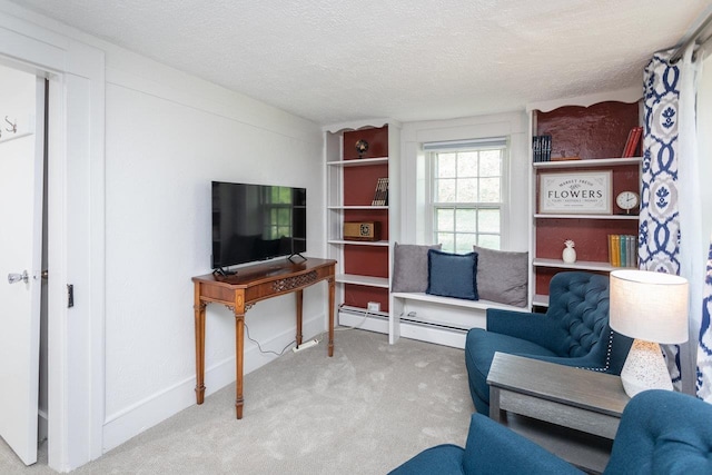 carpeted living area with a textured ceiling, baseboards, and a baseboard radiator