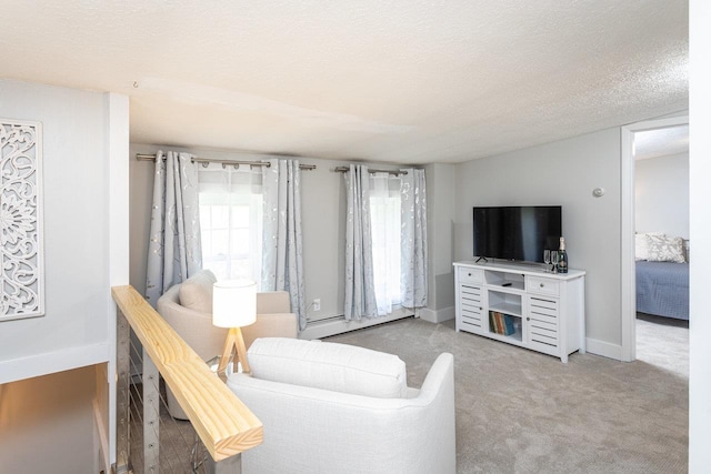 carpeted living room featuring a baseboard heating unit, baseboards, and a textured ceiling