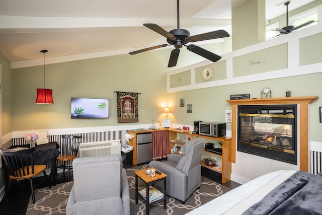 living room featuring high vaulted ceiling, a multi sided fireplace, and ceiling fan