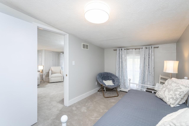 bedroom featuring visible vents, baseboards, a textured ceiling, and carpet flooring