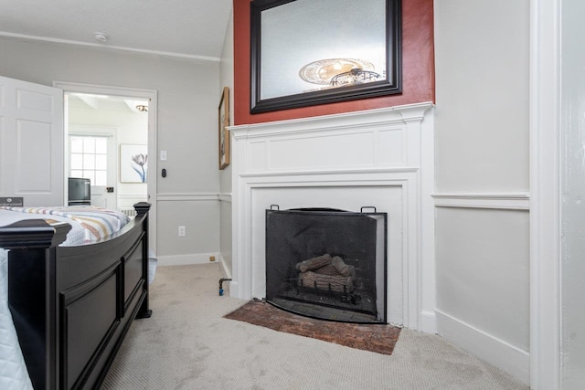 living area with a fireplace with flush hearth, baseboards, and light carpet