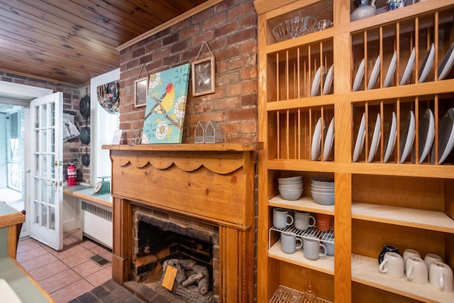 wine cellar with wooden ceiling, radiator, tile patterned floors, and brick wall