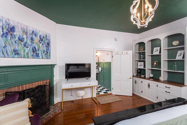 living area featuring a fireplace, wood finished floors, and a chandelier