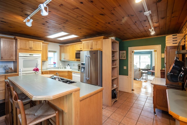 kitchen featuring plenty of natural light, appliances with stainless steel finishes, light tile patterned flooring, and light countertops