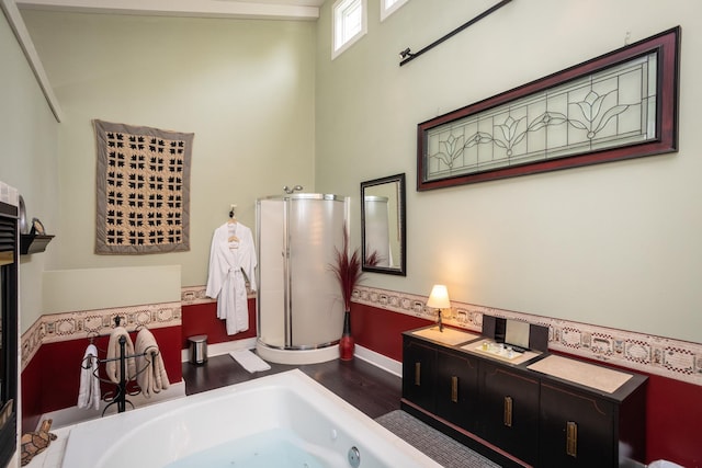 bathroom with a shower stall and a jetted tub