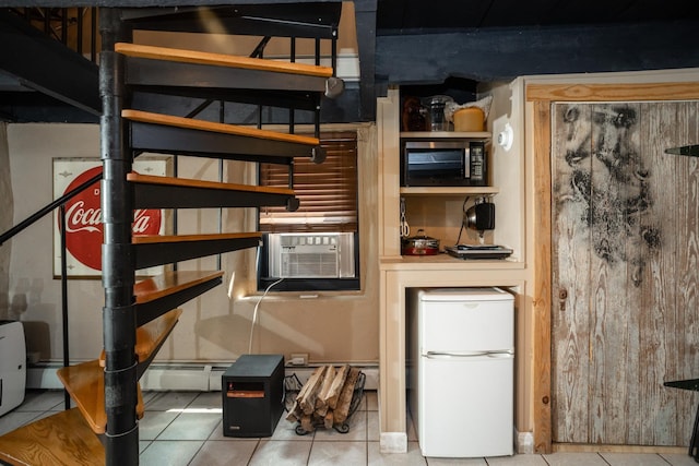 kitchen featuring stainless steel microwave, white fridge, cooling unit, tile patterned flooring, and a baseboard radiator