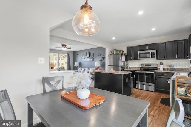 dining space featuring ceiling fan and light hardwood / wood-style flooring