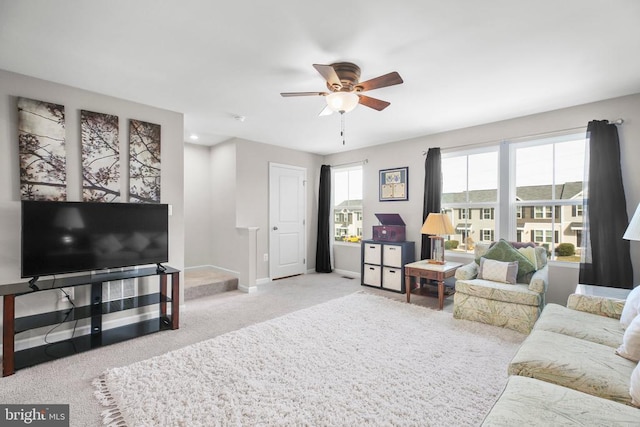 living room featuring ceiling fan and light colored carpet