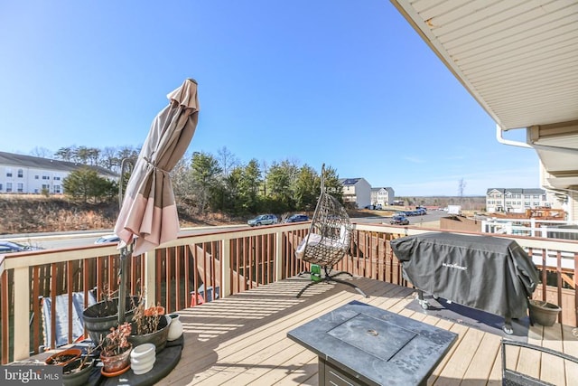 wooden terrace featuring grilling area