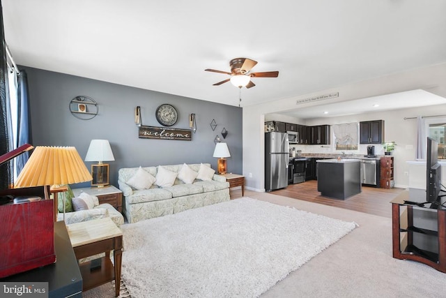 living room with sink and ceiling fan