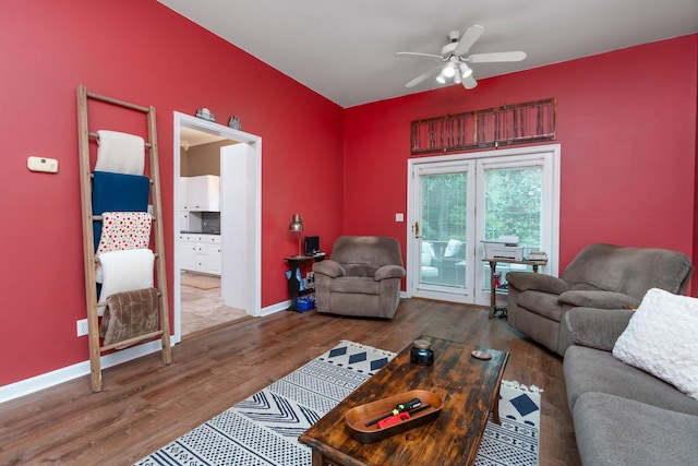 living room featuring hardwood / wood-style floors and ceiling fan