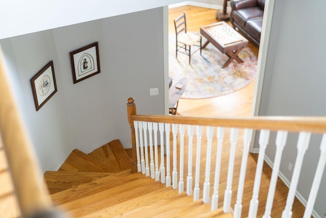 stairs featuring hardwood / wood-style flooring