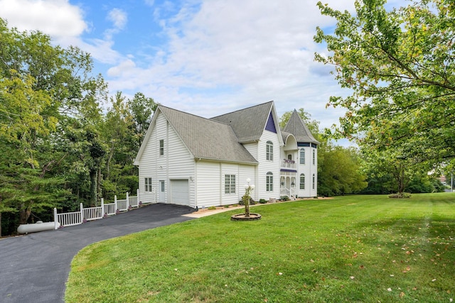 view of property exterior with a yard and a garage