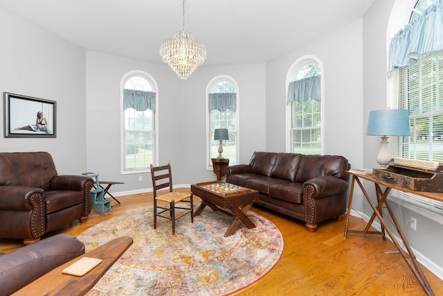 living room with an inviting chandelier and light wood-type flooring