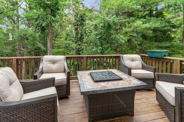 wooden deck with an outdoor living space with a fire pit