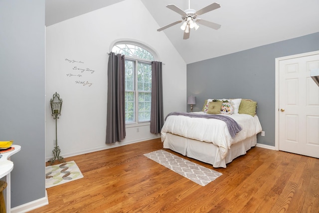 bedroom with high vaulted ceiling, light hardwood / wood-style floors, and ceiling fan