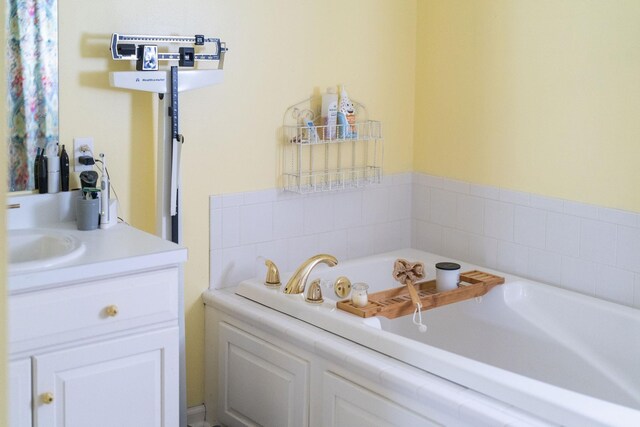 bathroom with vanity and a bath