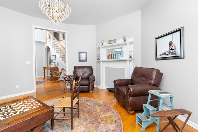 living area with wood-type flooring and a chandelier