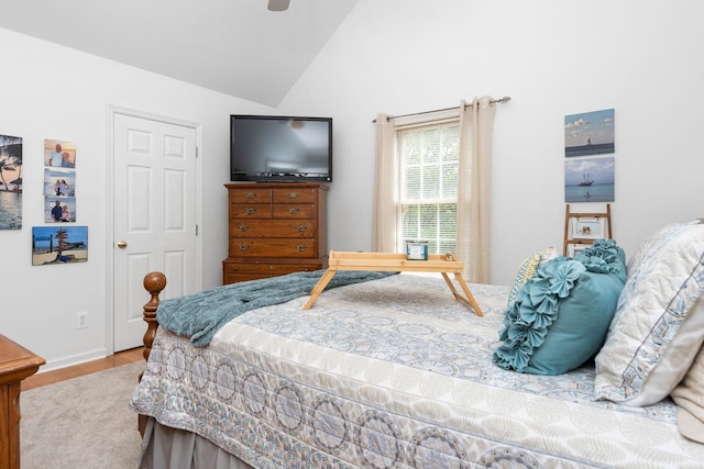 bedroom featuring lofted ceiling, light wood-type flooring, and ceiling fan