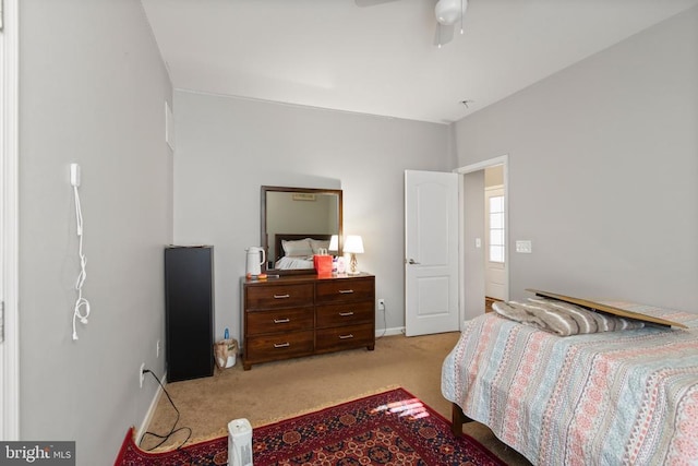 bedroom featuring light colored carpet, ceiling fan, and baseboards