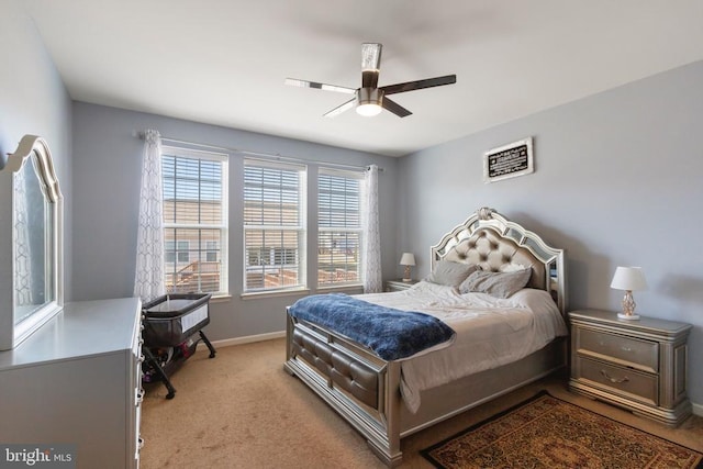 bedroom featuring a ceiling fan, light colored carpet, and baseboards