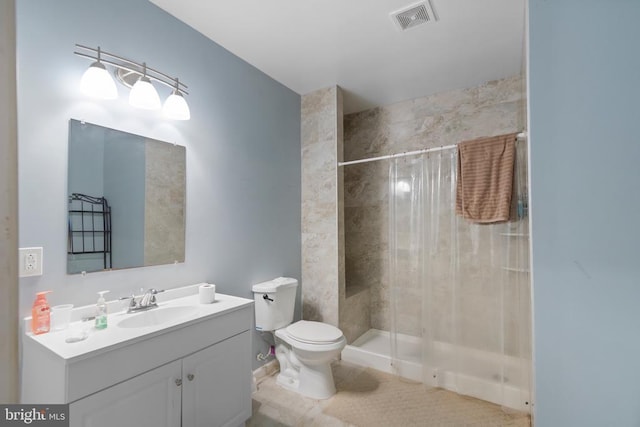 bathroom with visible vents, toilet, a shower stall, and vanity