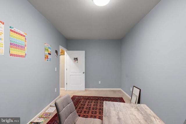 bedroom featuring baseboards and light colored carpet