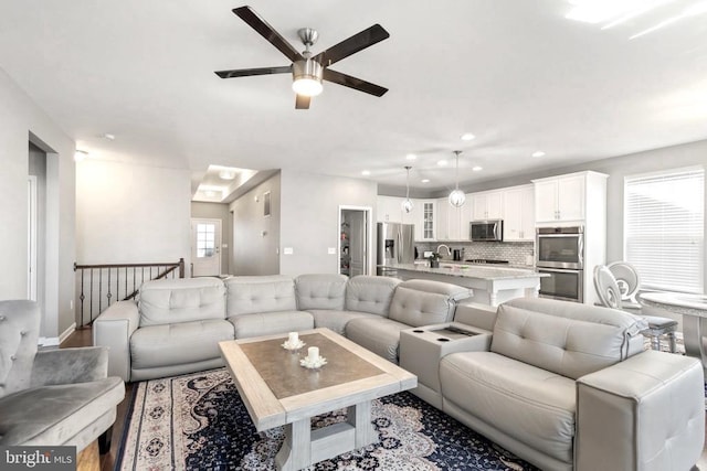 living area with a ceiling fan and recessed lighting