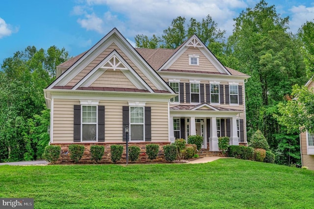 view of front of home featuring covered porch and a front lawn